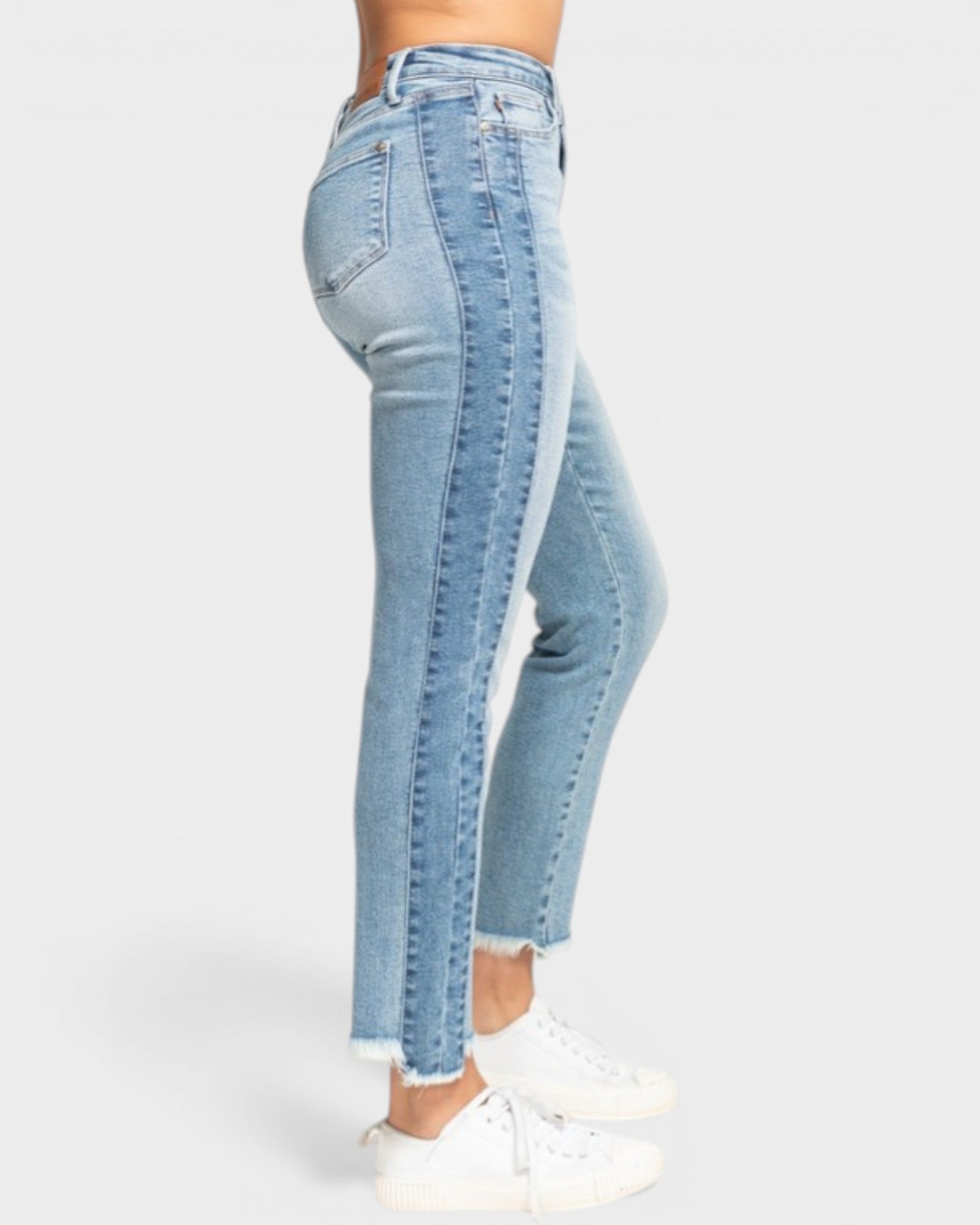 Light blue jeans worn by a person on a white background