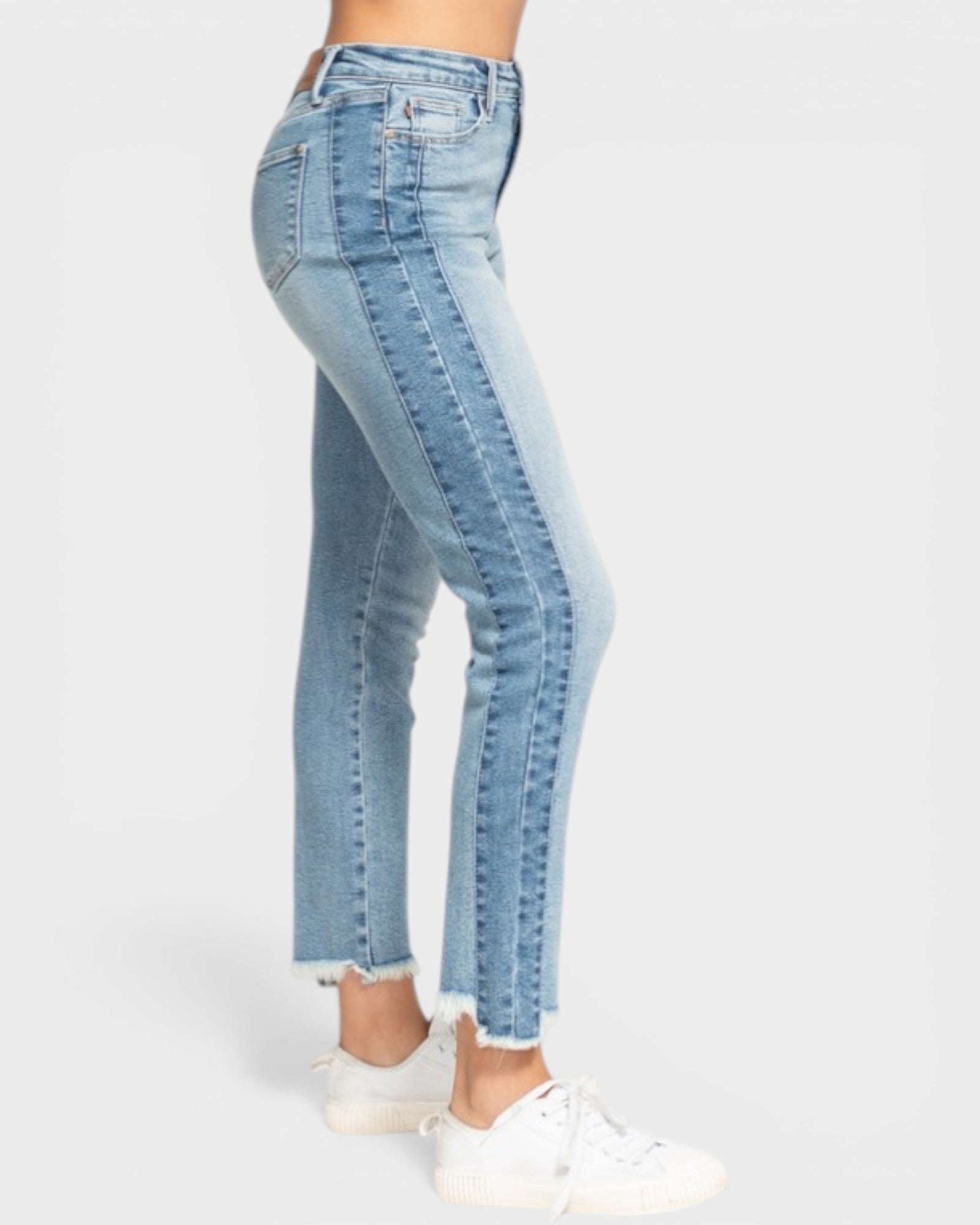 Light blue jeans worn by a person on a white background
