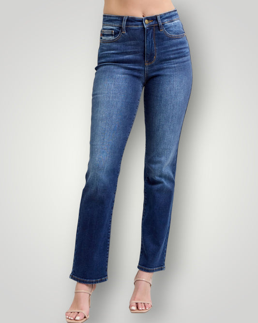 Blue jeans worn by a person on a plain background