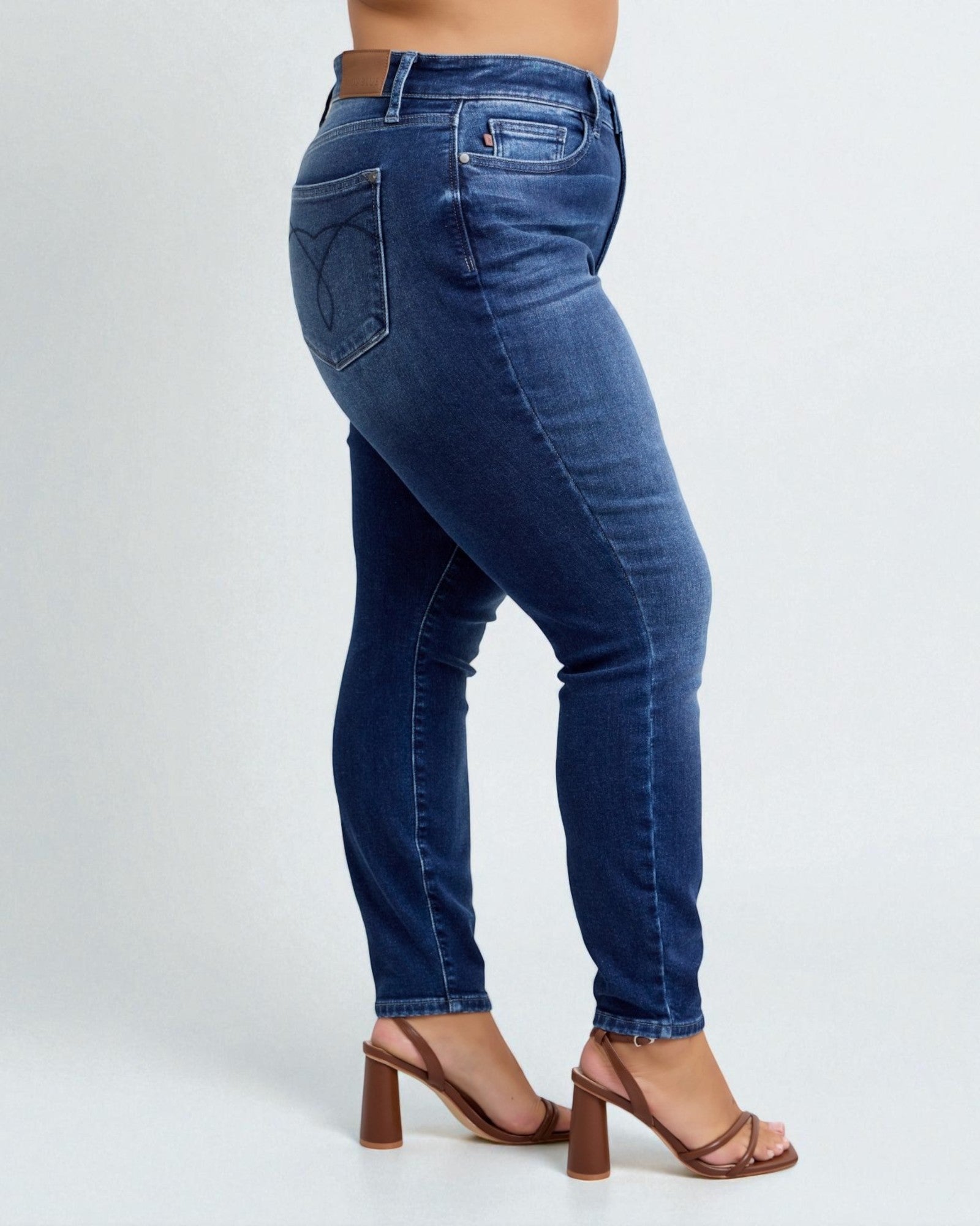 Blue jeans worn by a person on a white background