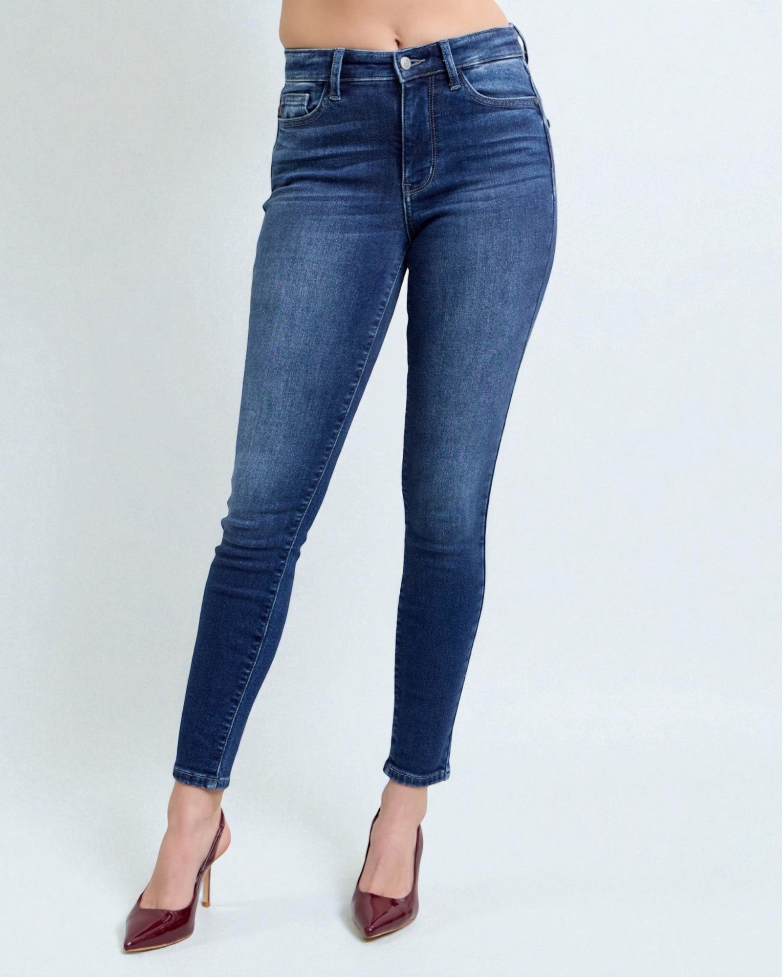 Blue jeans worn by a person on a white background