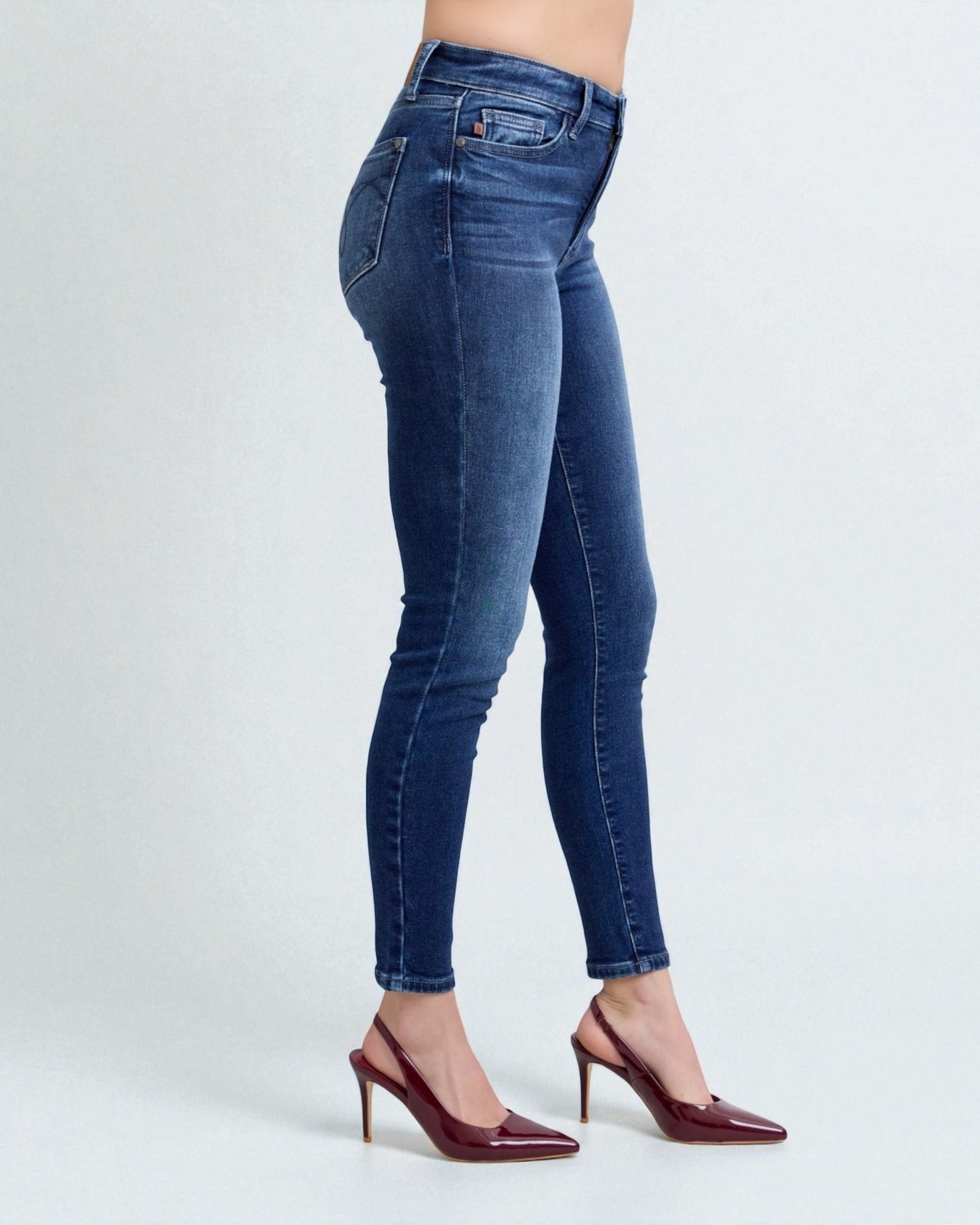 Blue jeans worn by a person on a white background