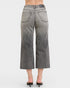 Person wearing gray wide-leg jeans on a white background