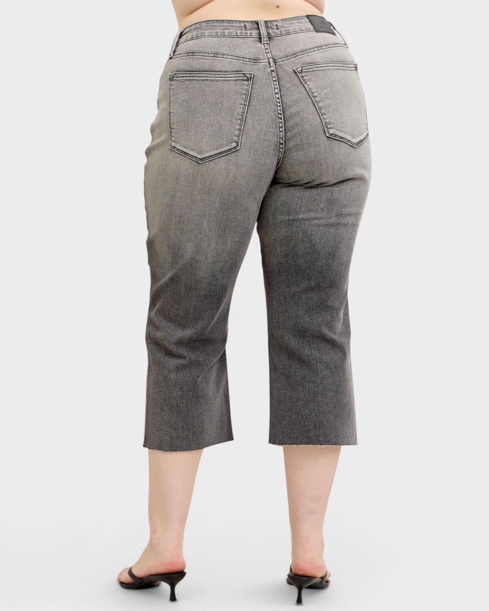 Gray capri jeans on a white background