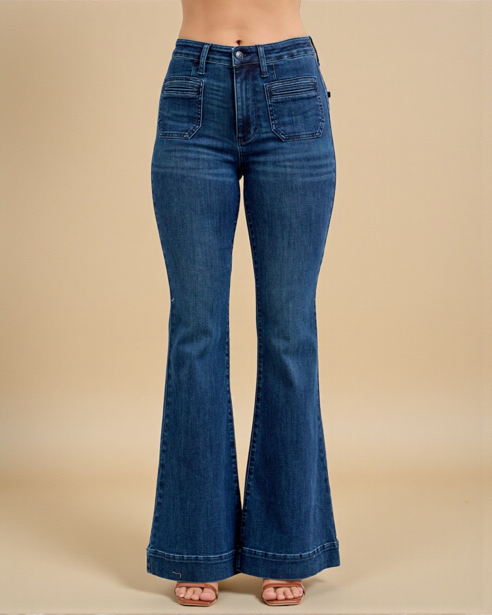 Blue flared jeans on a beige background