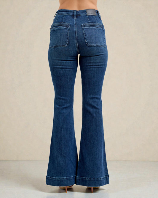 Blue flared jeans on a beige background