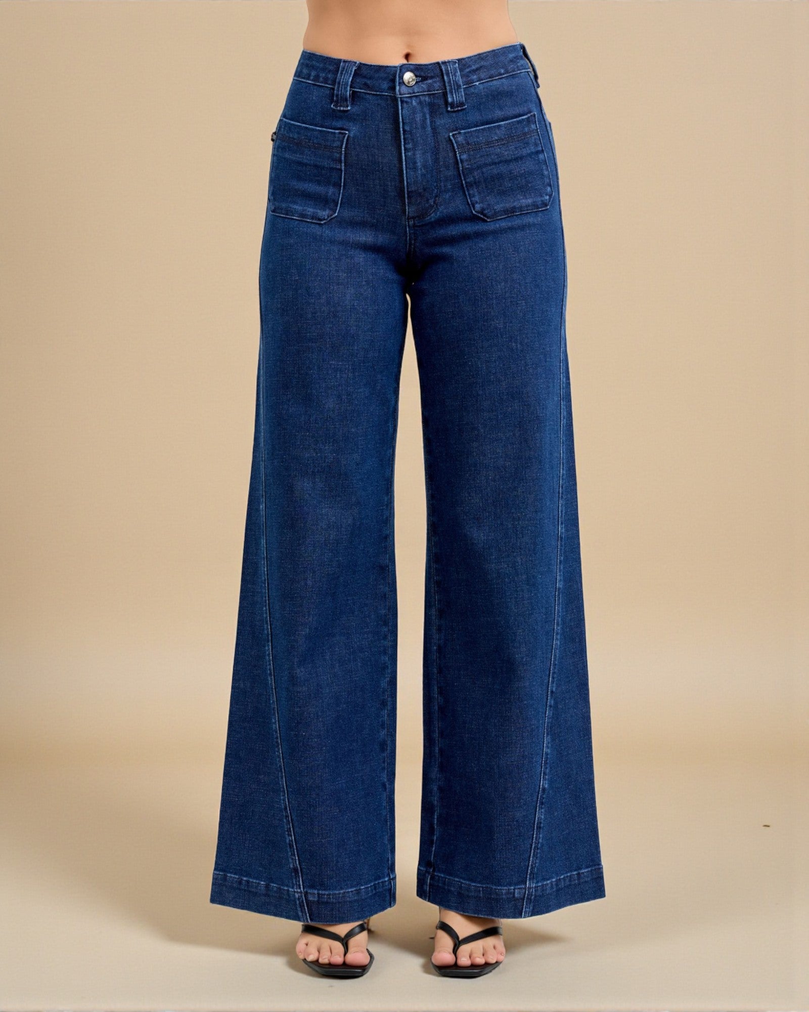 Blue wide-leg jeans on a beige background