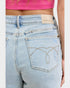 Light blue jeans with a brand label on the back pocket, worn by a person.