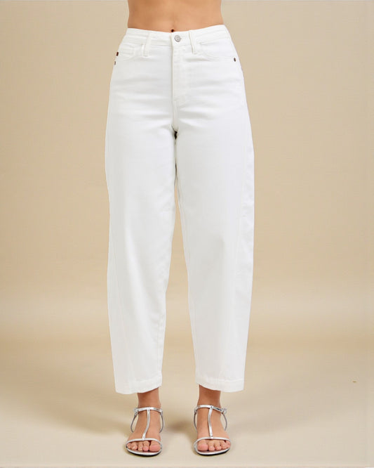 White jeans worn by a person on a beige background