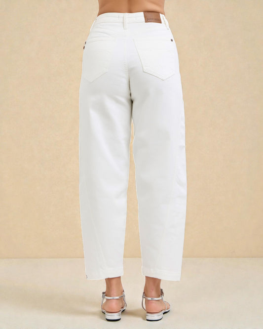 White pants worn by a person on a beige background