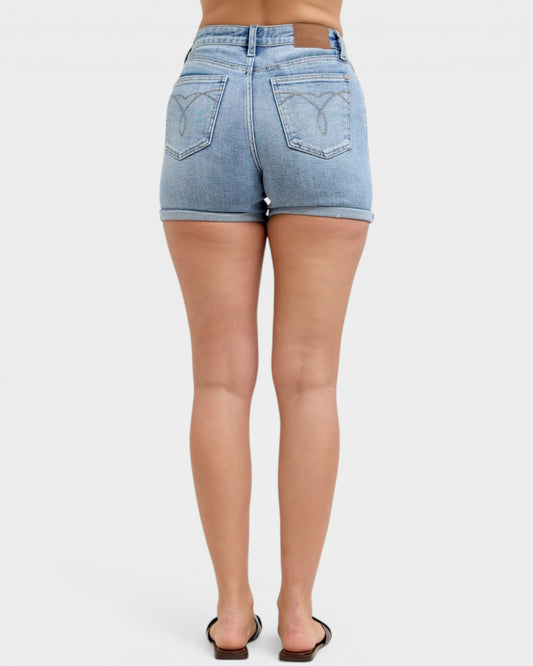 Person wearing light blue denim shorts on a white background