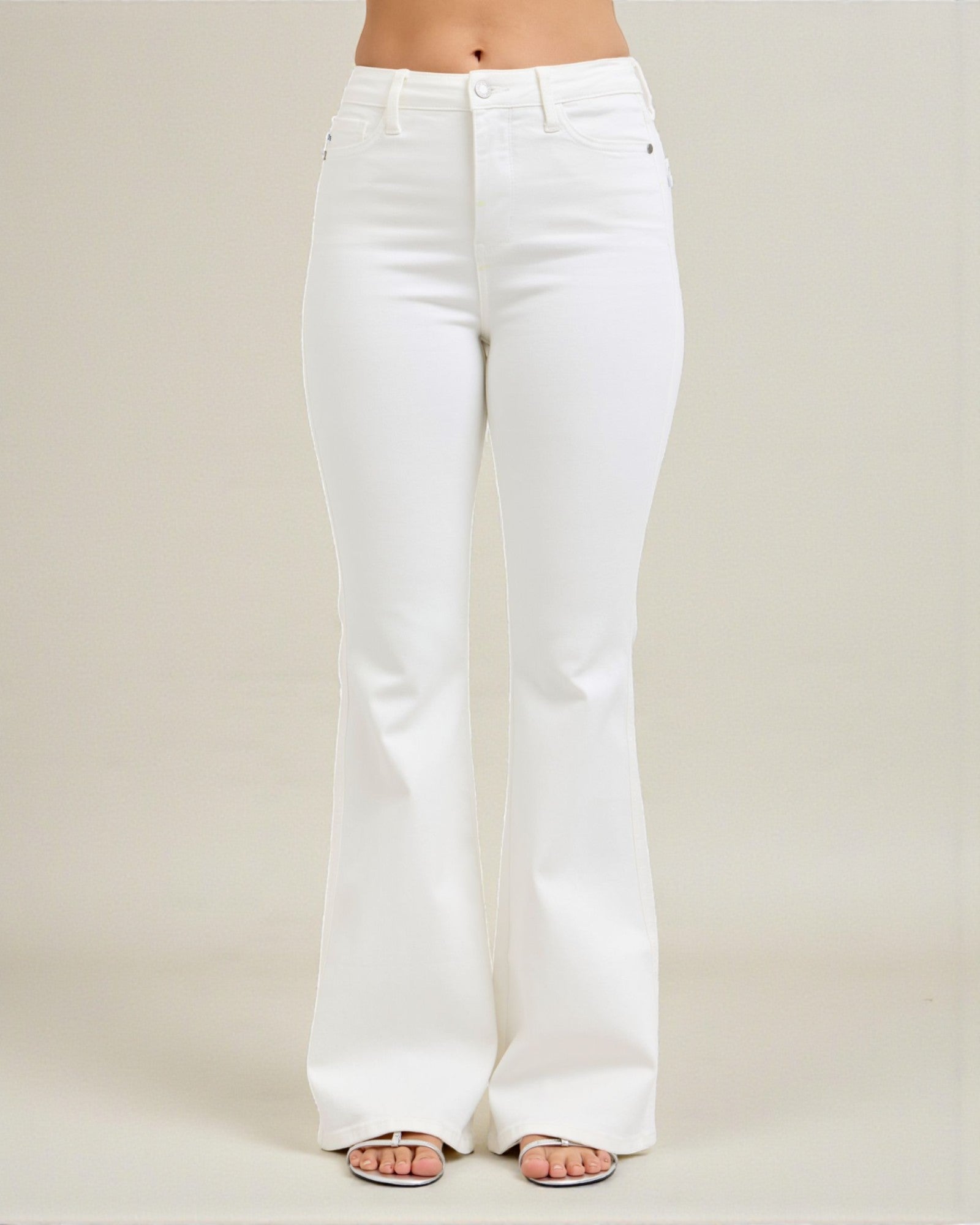 White jeans worn by a person on a plain background
