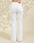 White flared jeans on a floral patterned background