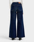 Dark blue wide-leg jeans worn by a person on a white background