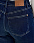 Close-up of blue jeans with a Judy Blue label on the back pocket.