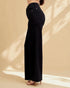 Black wide-leg pants worn by a person on a beige background