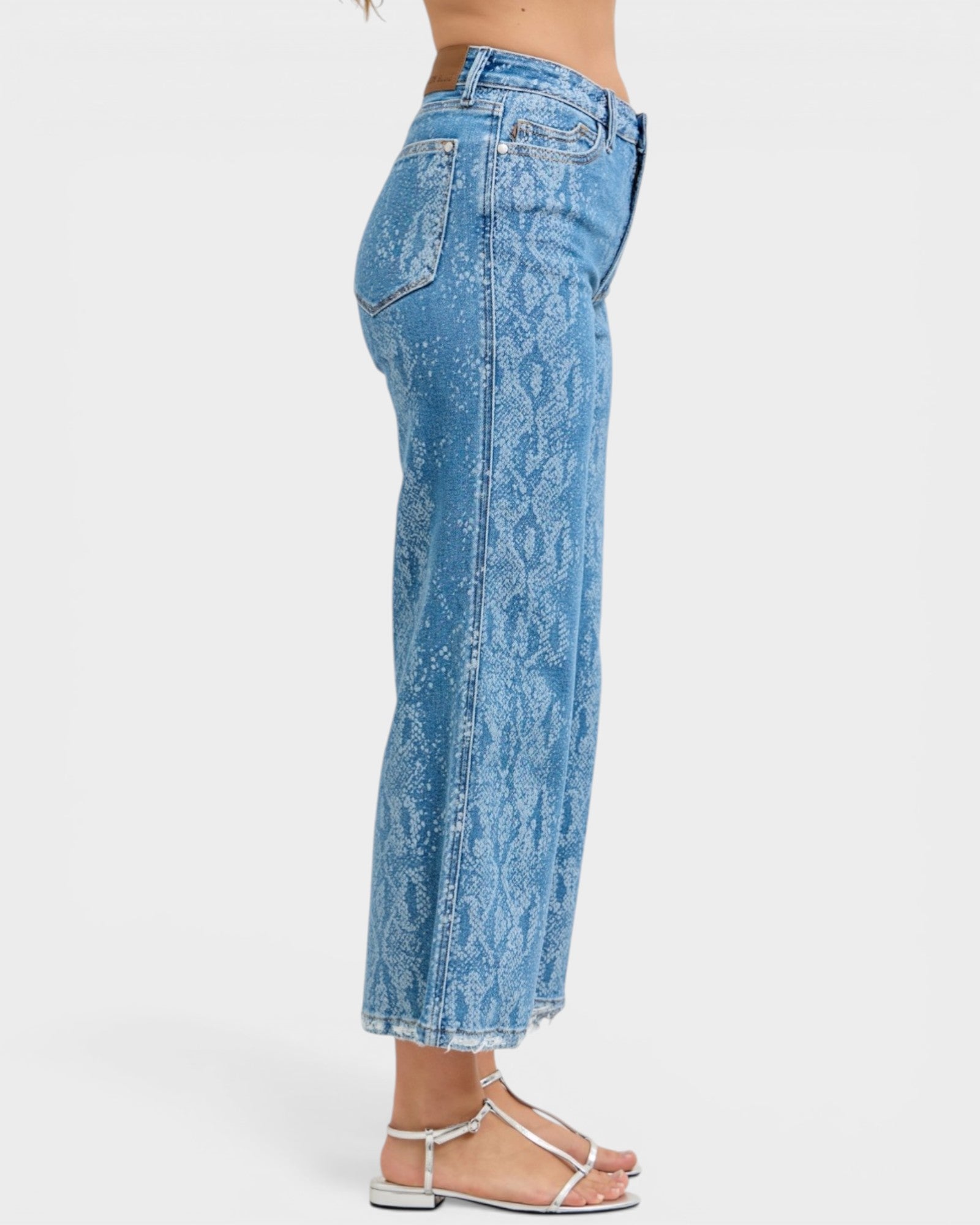 Blue acid-wash jeans worn by a person on a white background