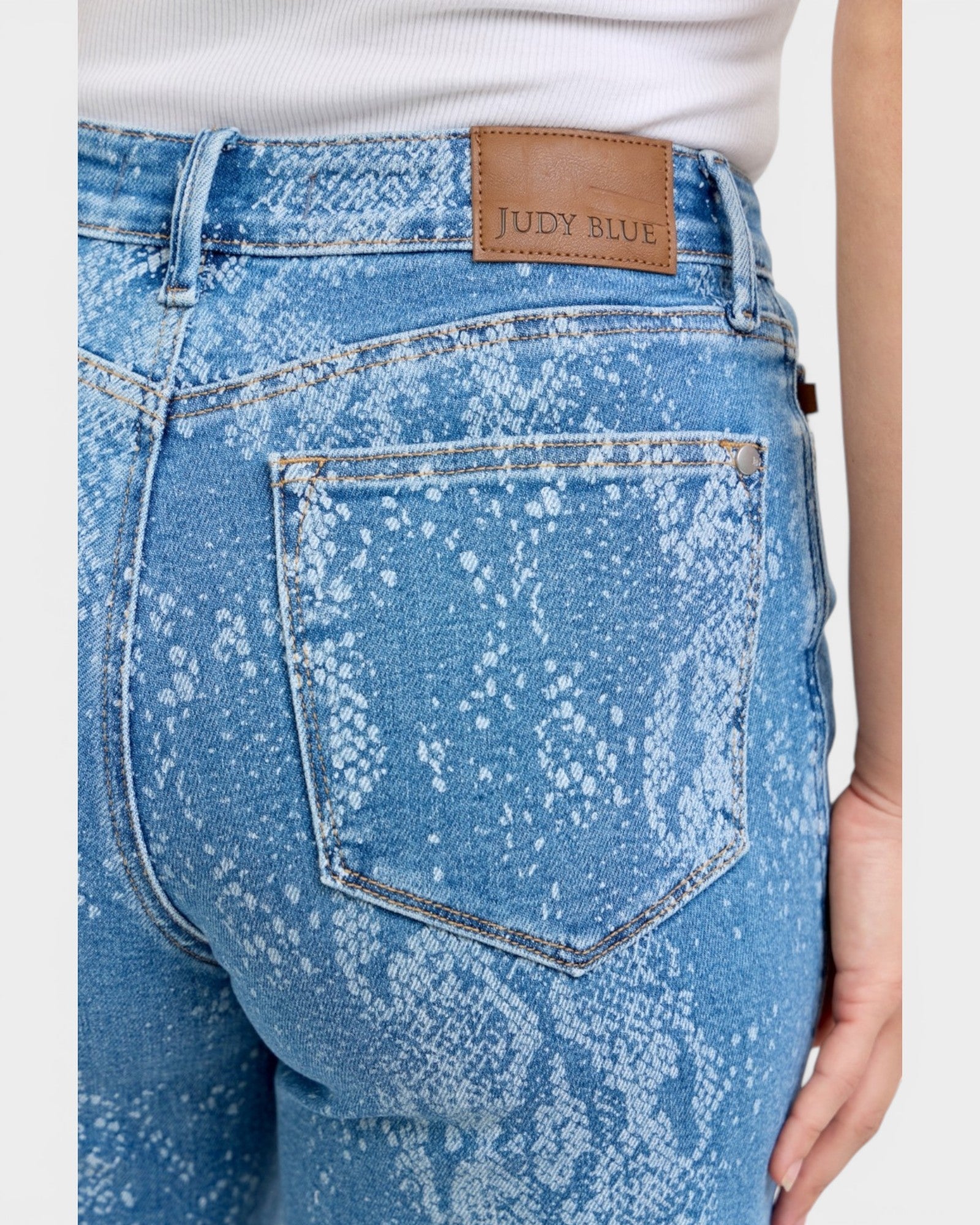 Blue acid-wash jeans with a Judy Blue label on a white background