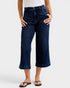 Person wearing dark blue jeans on a white background
