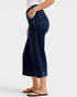 Person wearing dark blue jeans on a white background