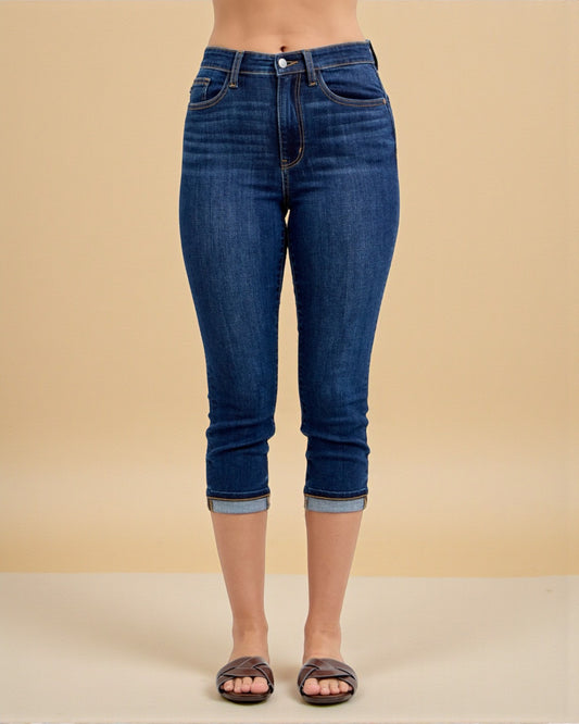 Blue jeans worn by a person on a beige background