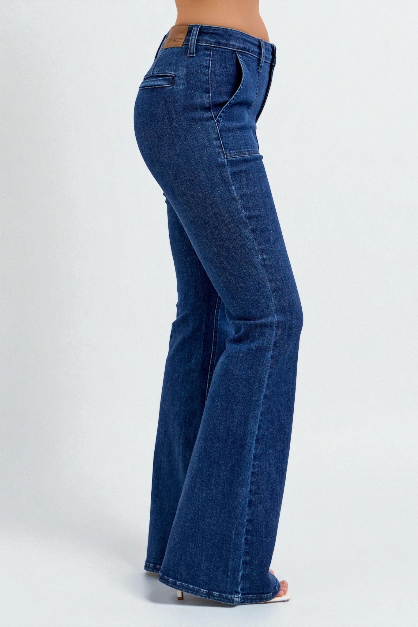 Blue jeans being worn on a white background