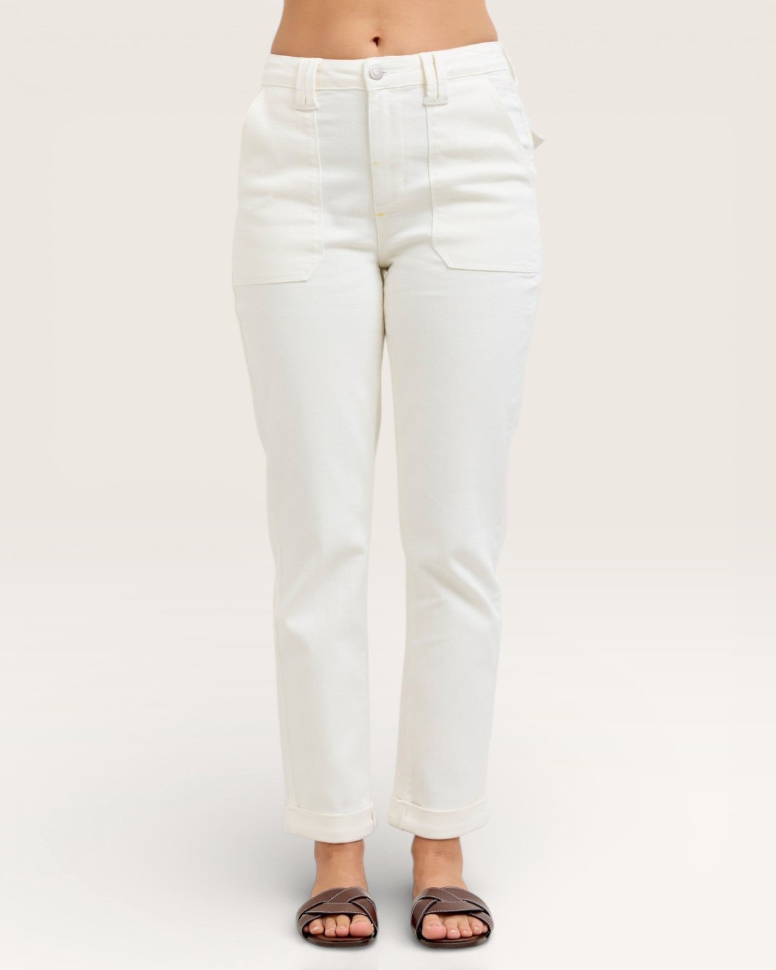 White jeans worn by a person on a white background