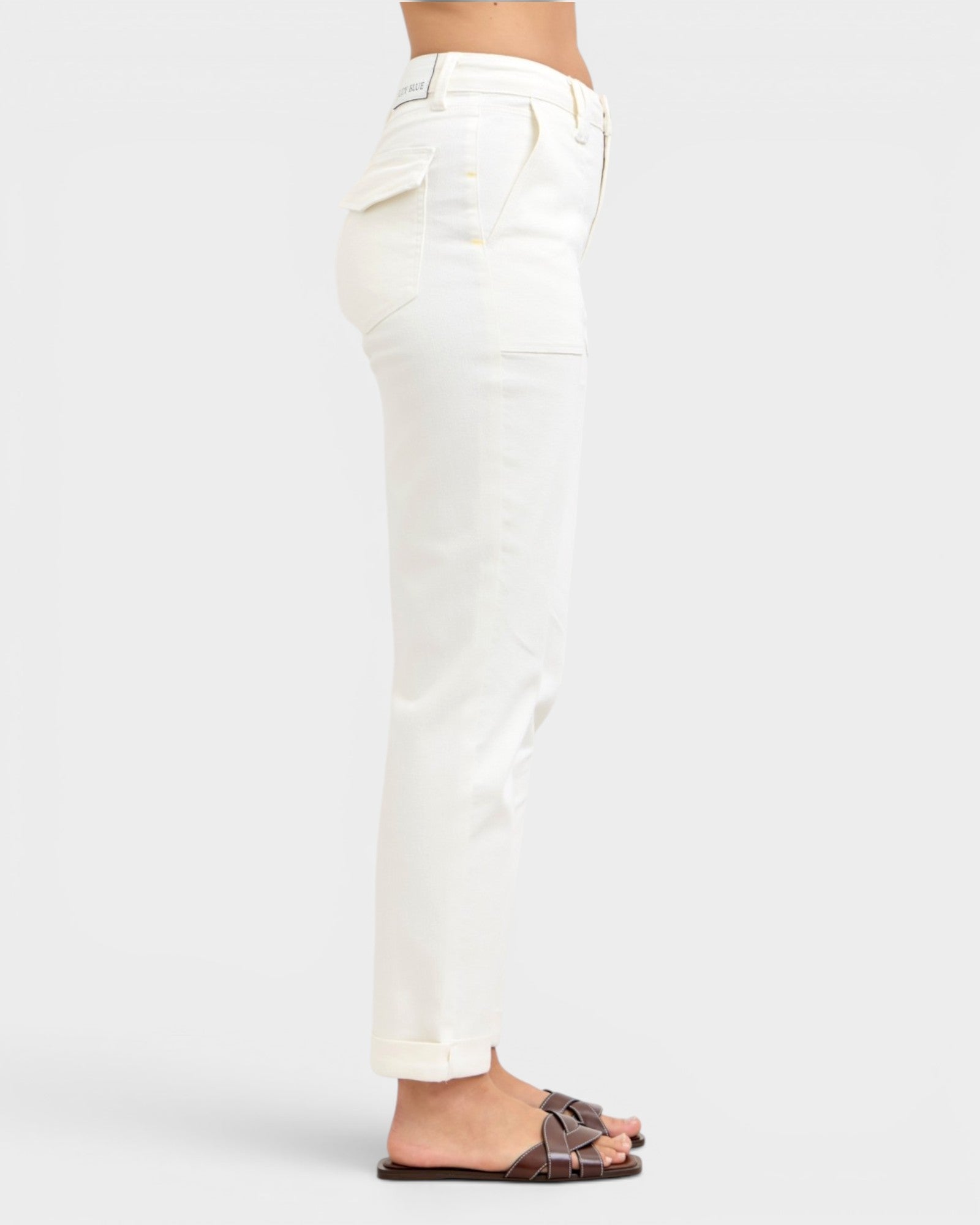White pants worn by a person on a white background