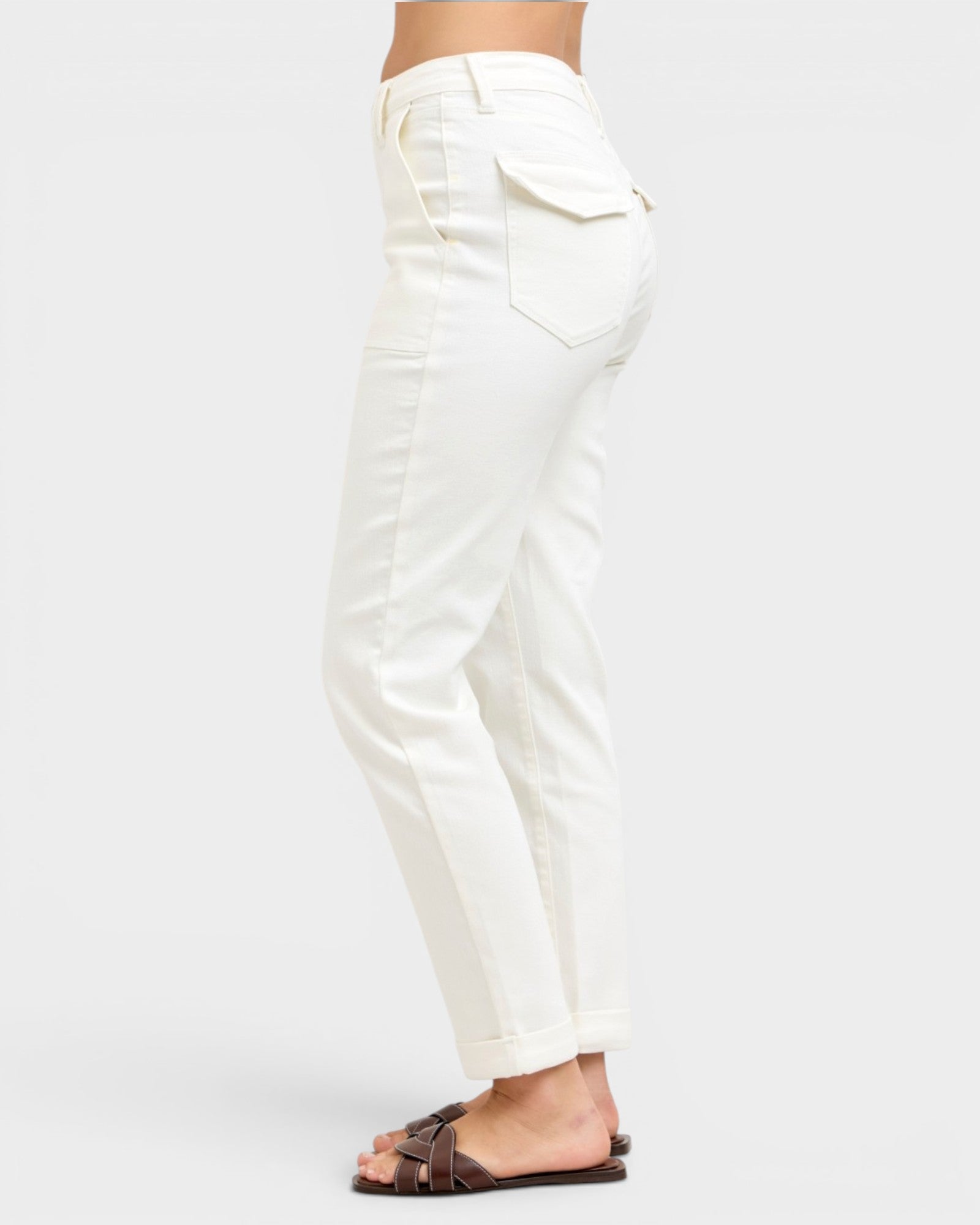 White pants worn by a person on a white background