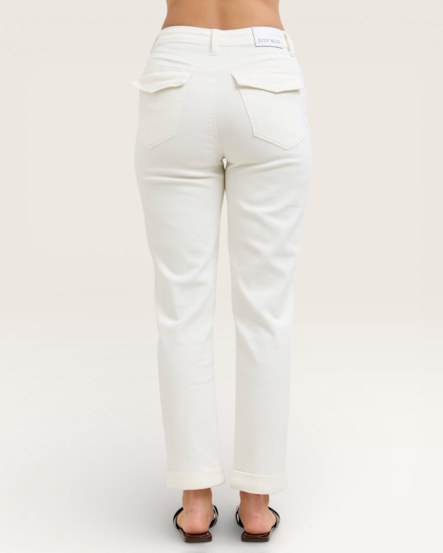 White jeans worn by a person on a white background