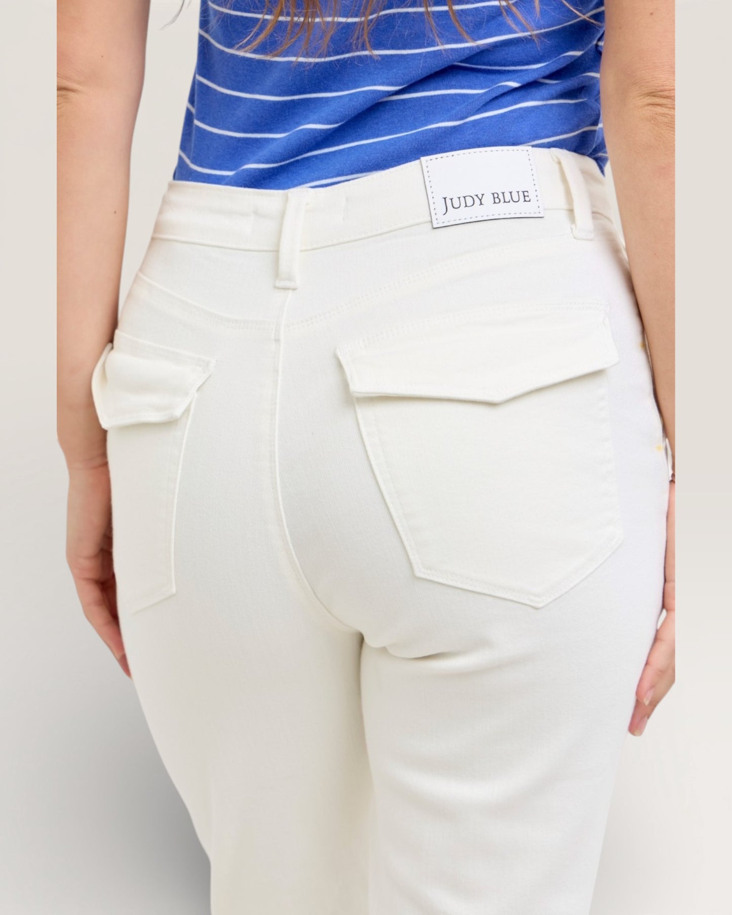 White pants with a visible brand label on a plain background