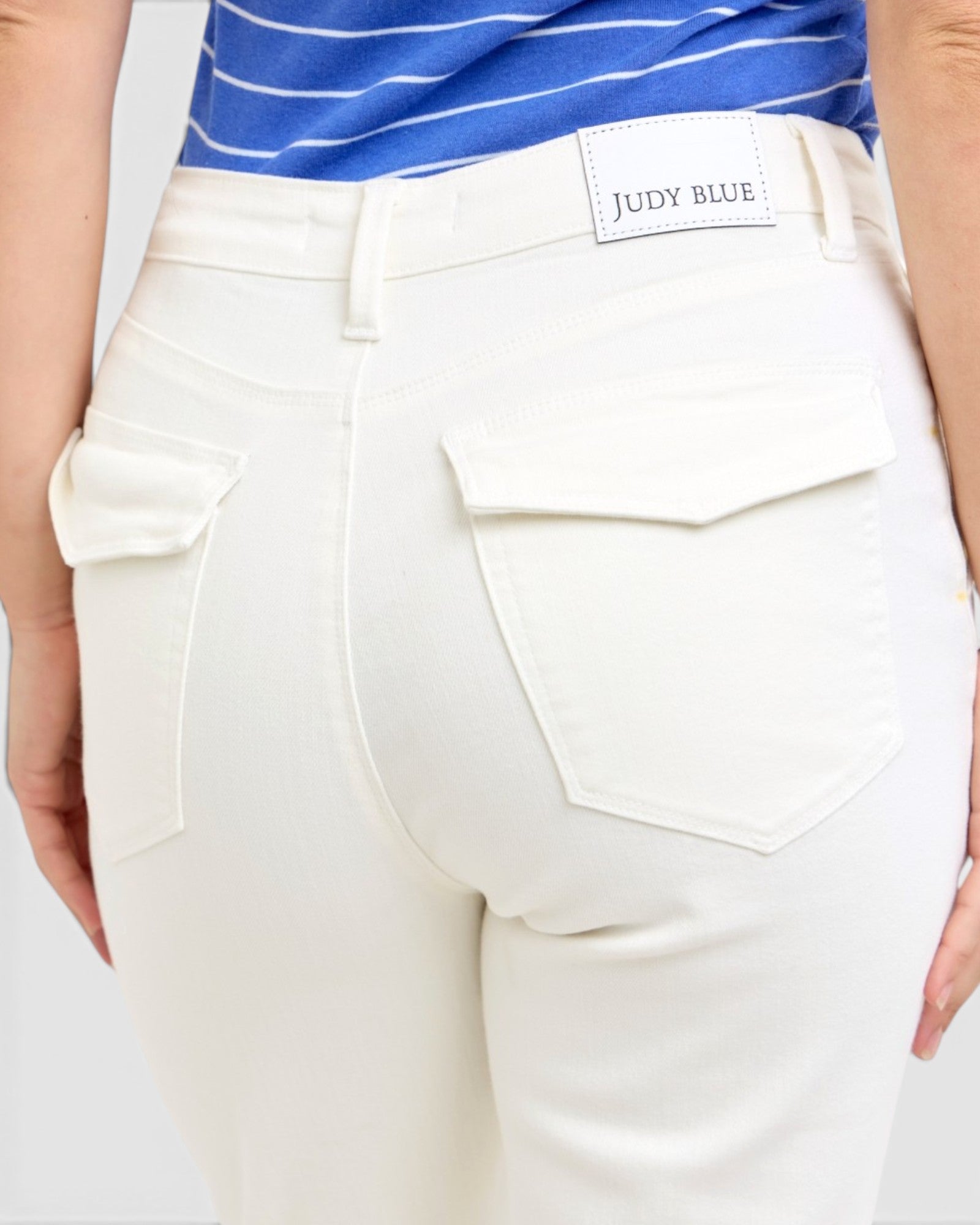 White pants with a visible brand label on a plain background