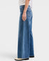 Person wearing blue jeans on a white background