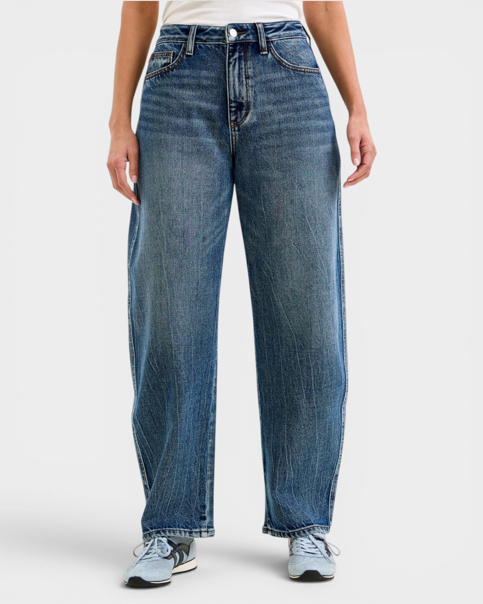 Person wearing blue jeans on a white background