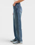 Person wearing blue jeans on a white background