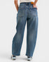 Person wearing blue jeans on a white background