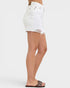 White denim skirt worn by a person on a white background