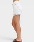 White denim shorts worn by a person on a white background