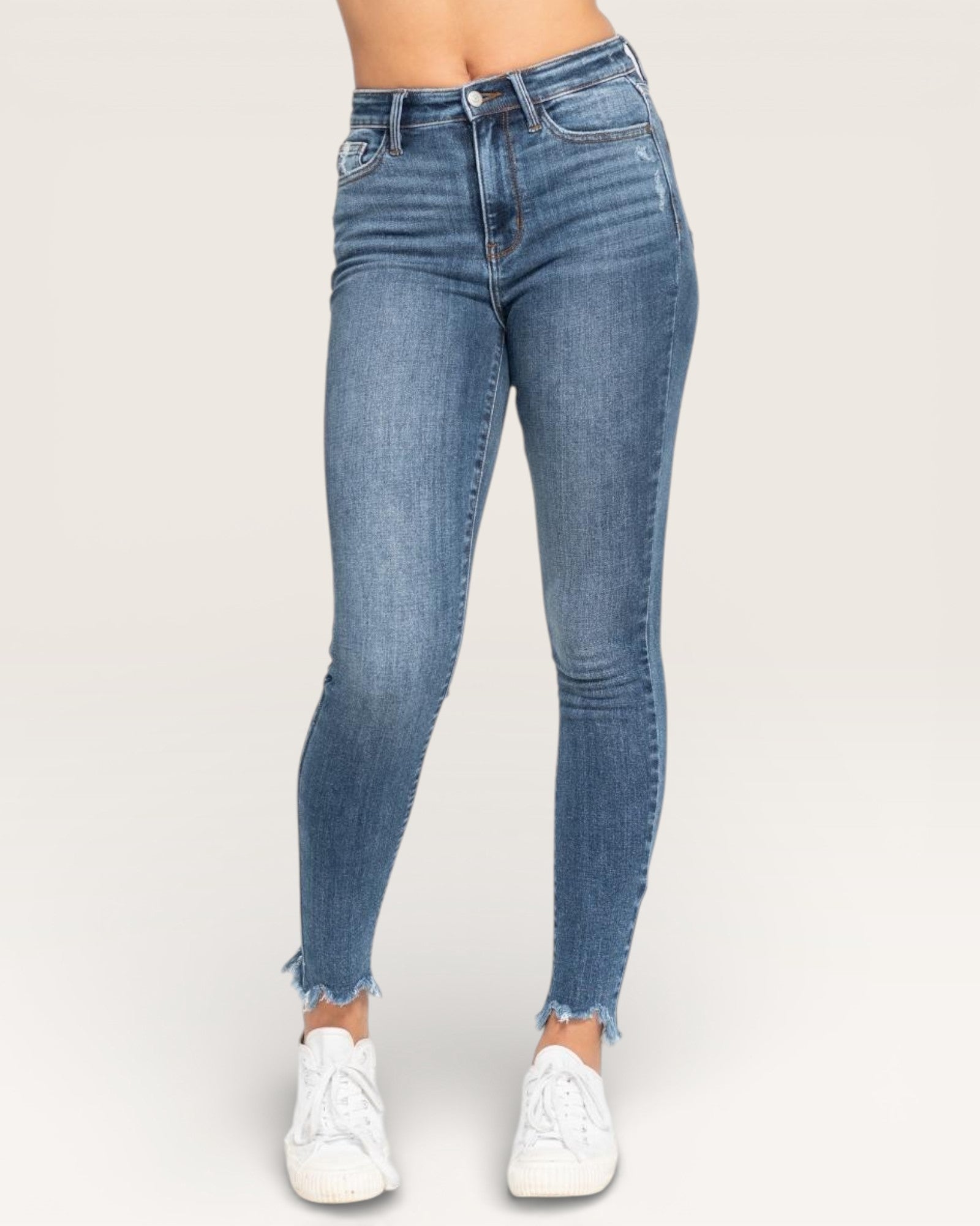 Blue jeans worn by a person on a white background