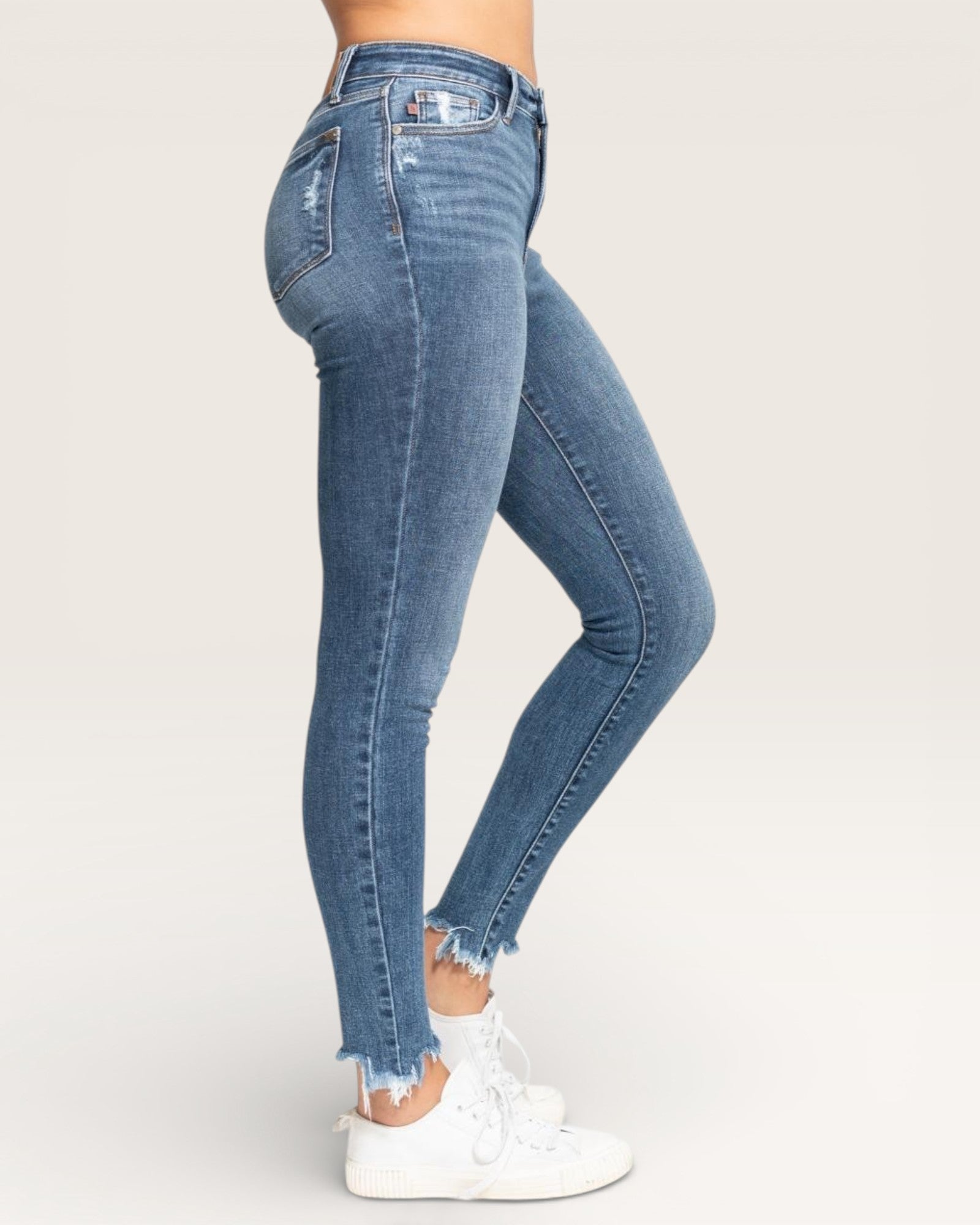Blue jeans worn by a person on a white background