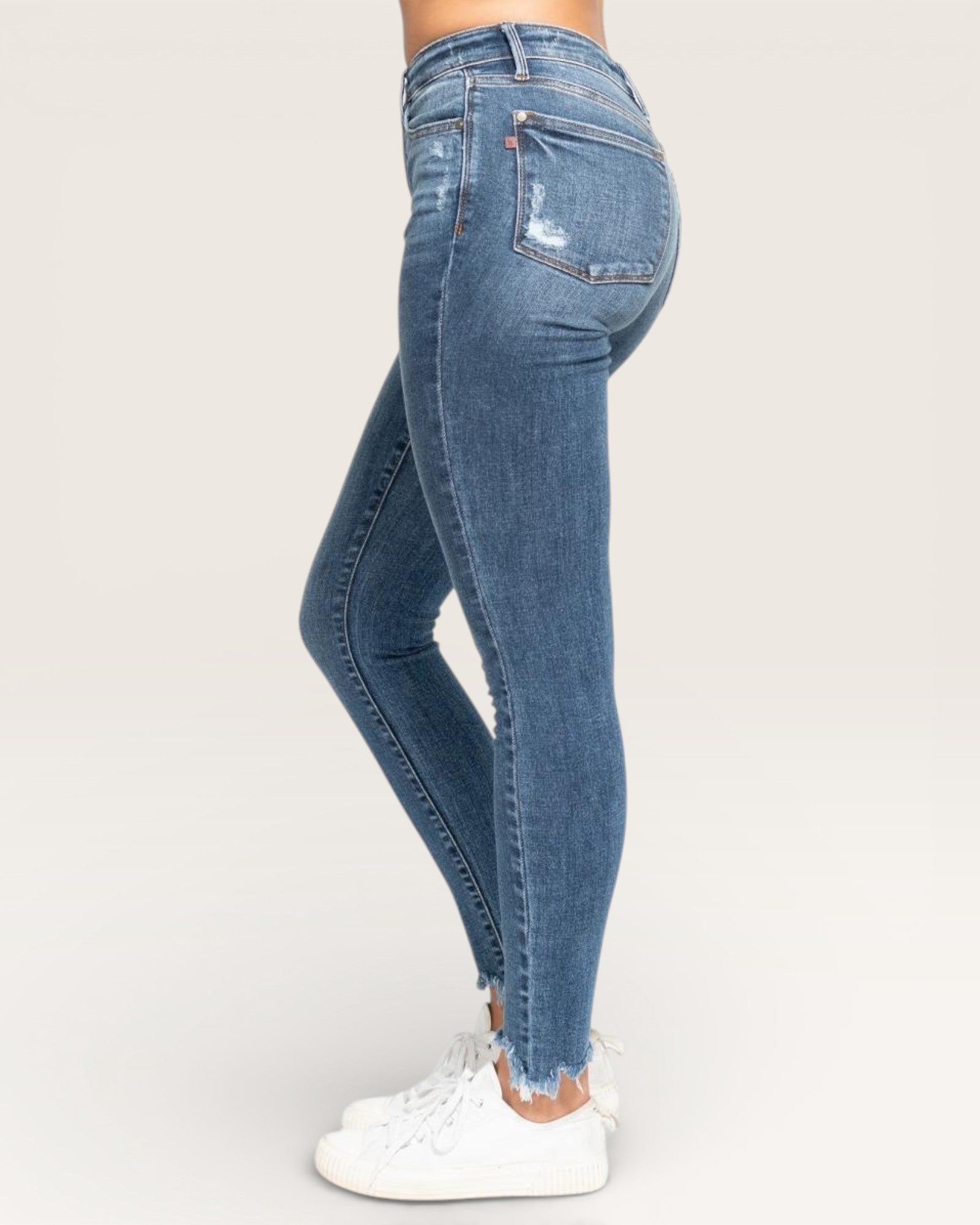 Blue jeans worn by a person on a white background