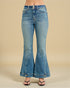 Blue flared jeans on a beige background