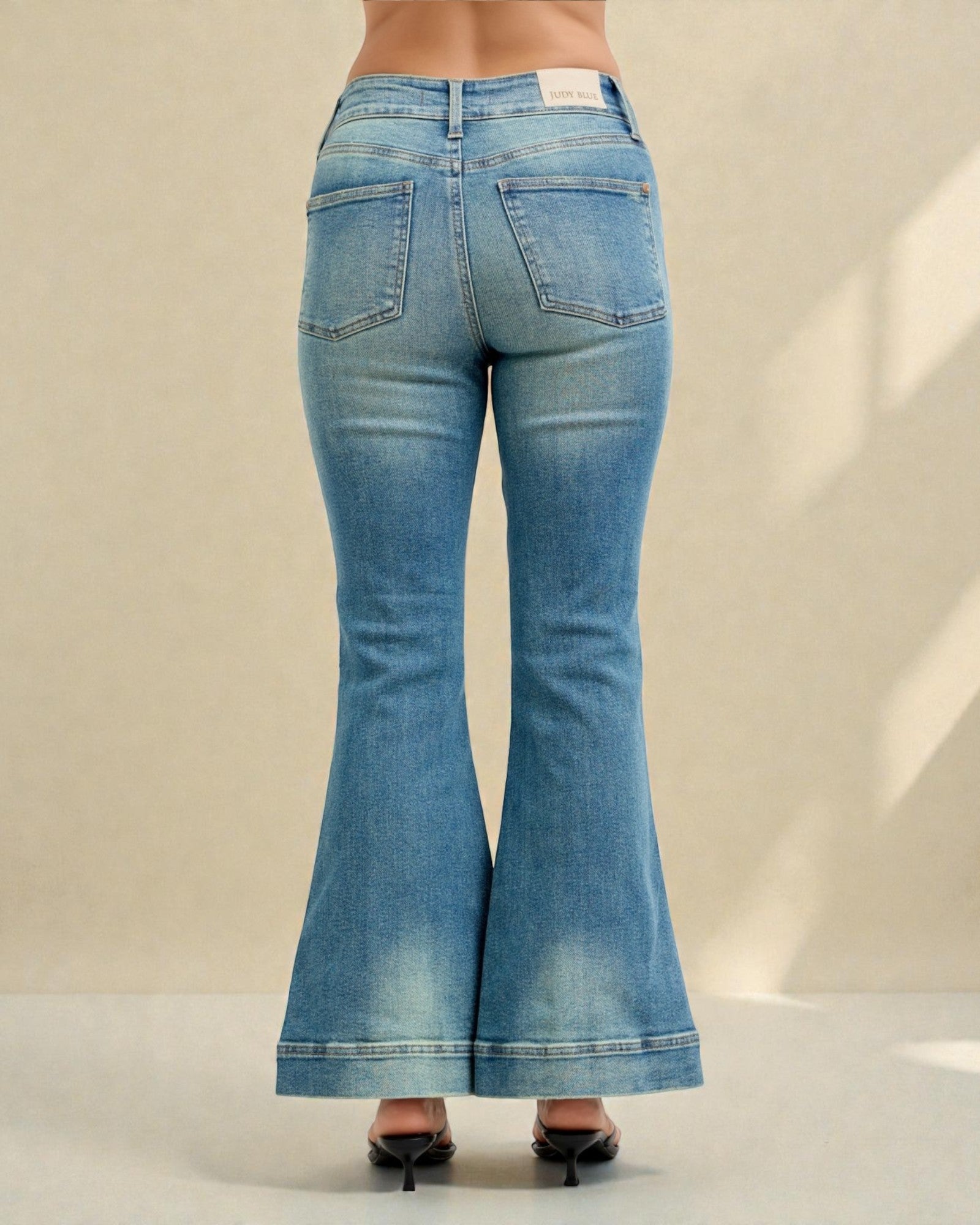 Blue flared jeans on a plain background