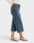 Person wearing blue jeans on a white background