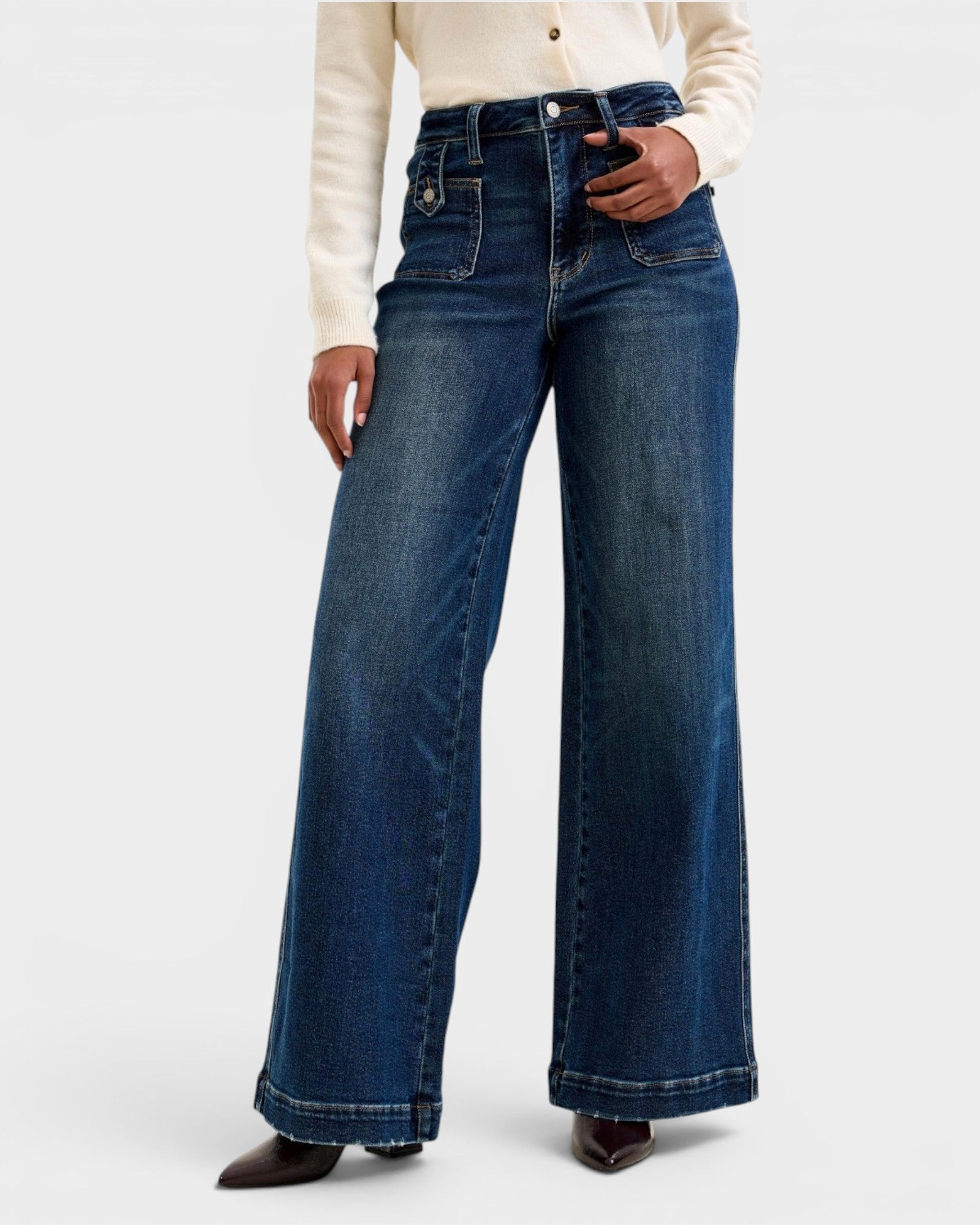 Person wearing blue wide-leg jeans on a white background