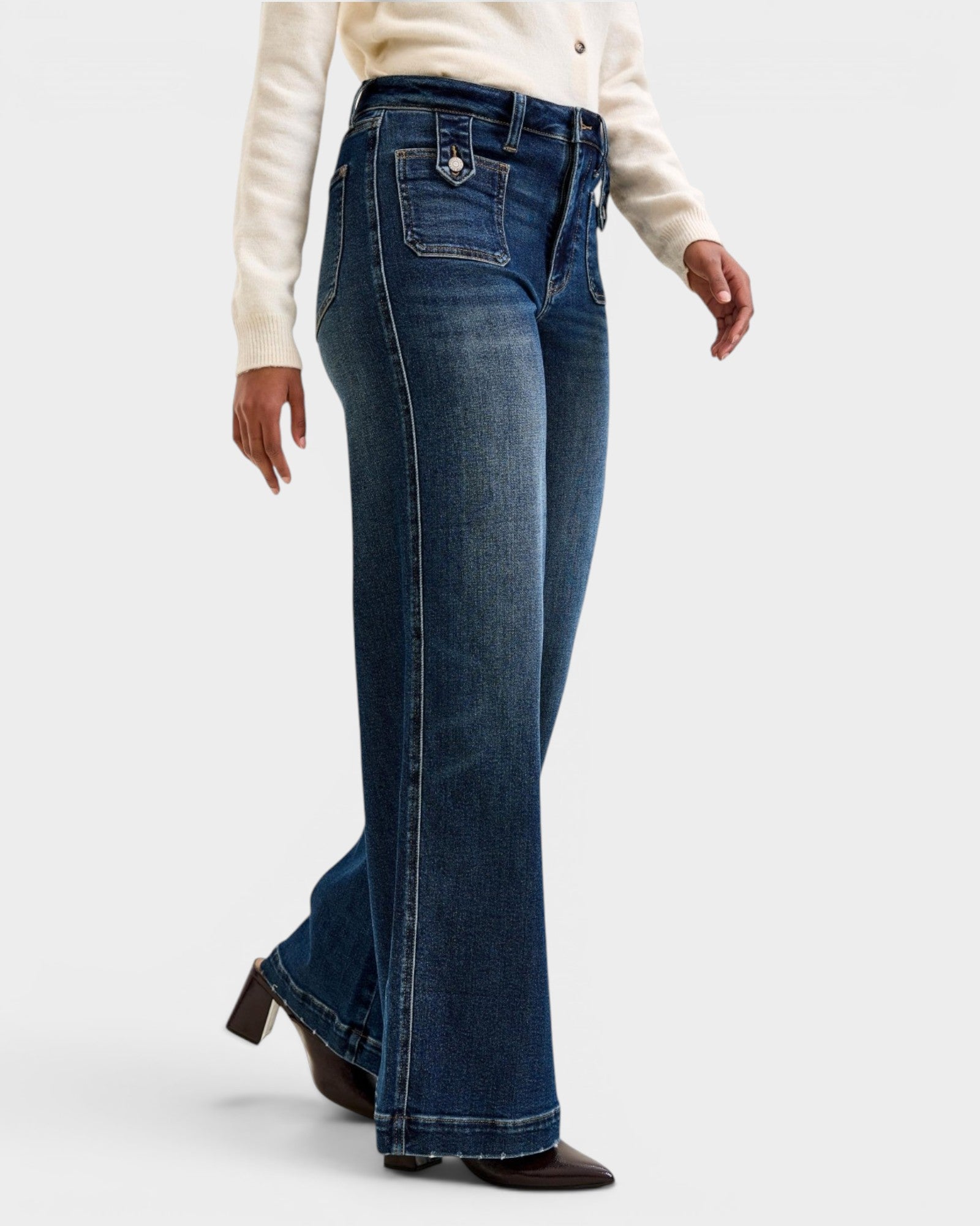 Person wearing blue jeans on a white background
