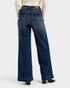 Blue jeans worn by a person on a white background