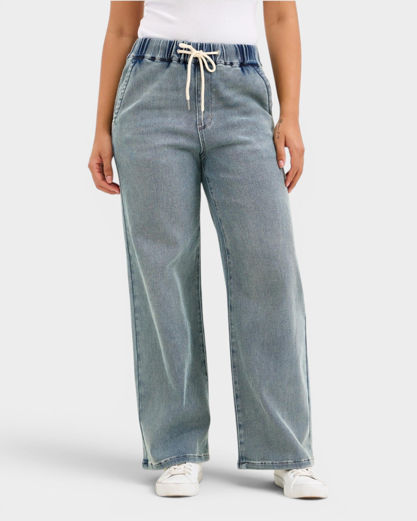 Light blue wide-leg jeans worn by a person on a white background