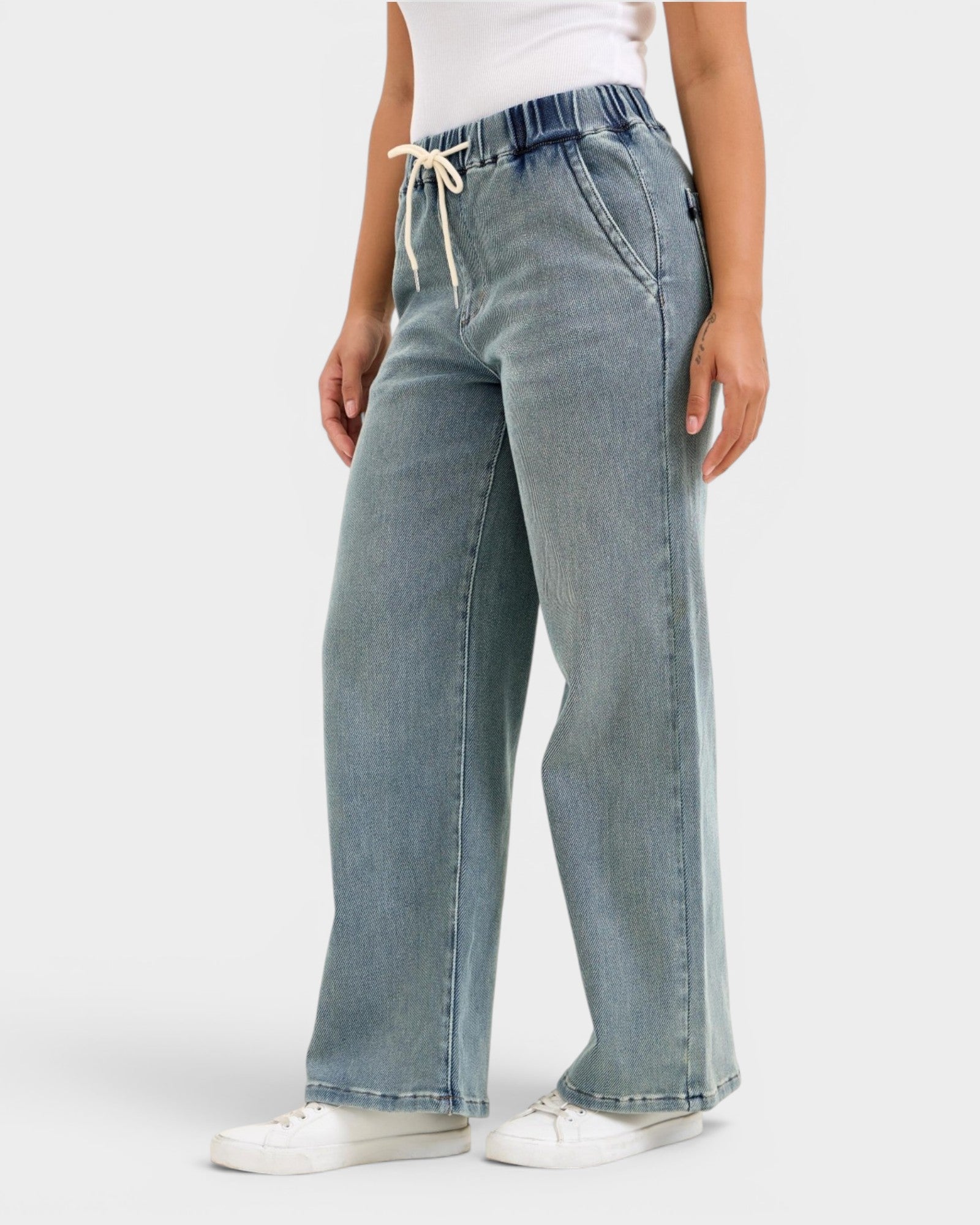Light blue jeans worn by a person on a white background