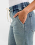 Light blue jeans with a drawstring waist on a white background